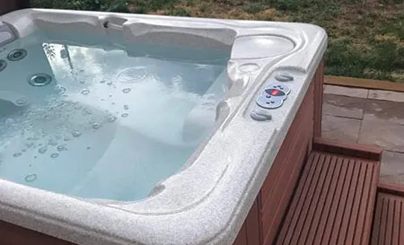 Hot tub being removed from a Palm Beach Gardens backyard