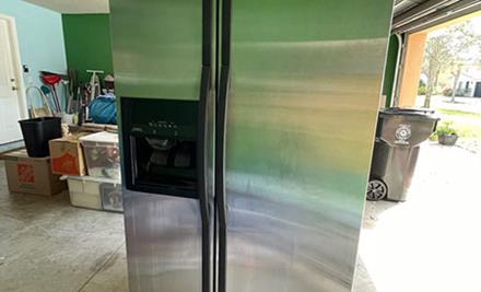 junk removal french door refrigerator in garage before pickup