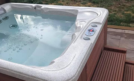 old outdoor hot tub for removal filled with water